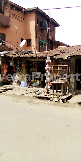  A burgalow building sitting on a half of plot having 5 shops infront of the building.  House for Sale Surulere Lagos Vetra  Property